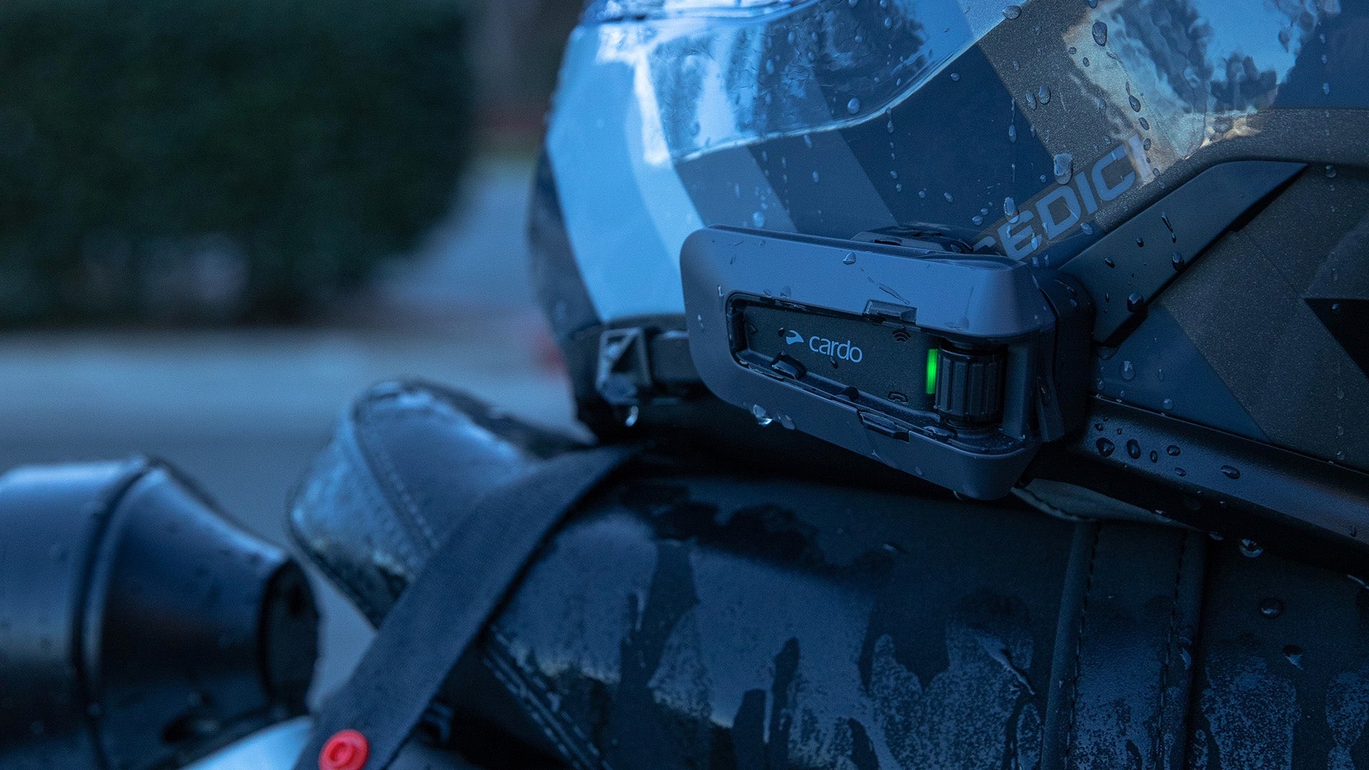 Close-up of Cardo Packtalk Edge on Helmet in rain