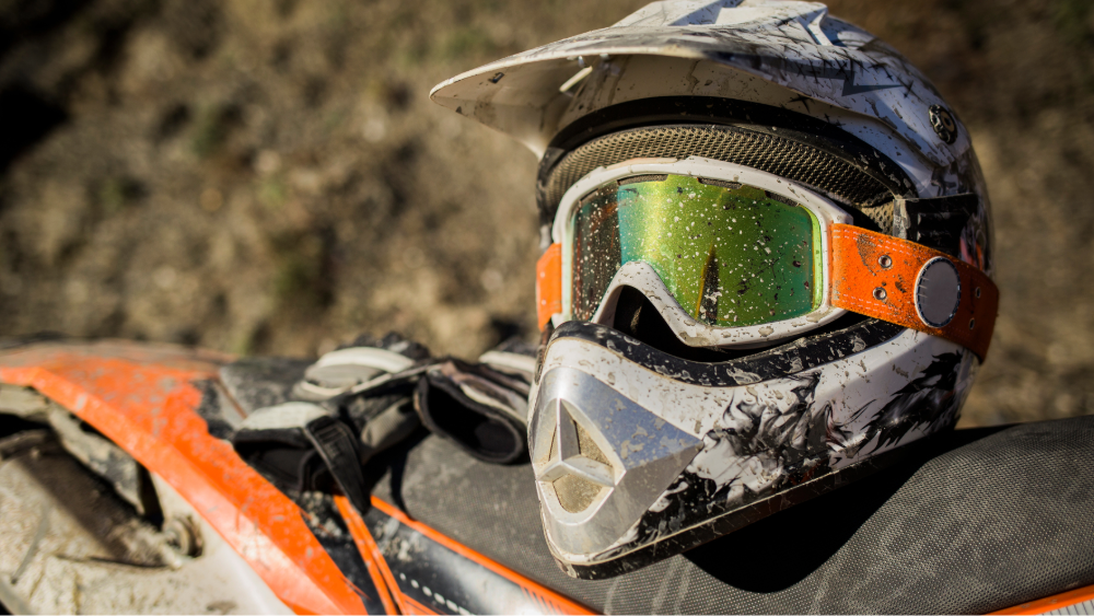 A worn motorcycle helmet on a seat with signs of aging
