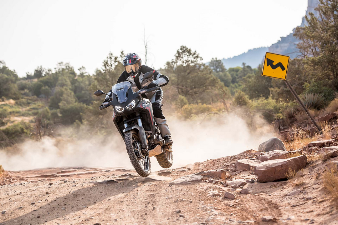 Adventure Motorcycle Rider riding over rocky terrain