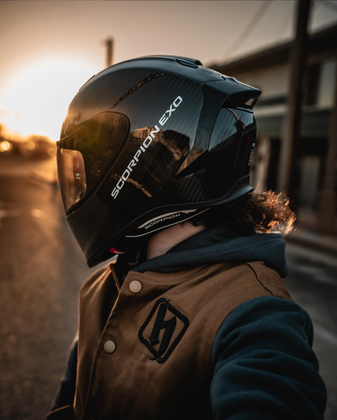 motorcycle at sunset wearing a Scorpion EXO-R1 Air Carbon Helmet