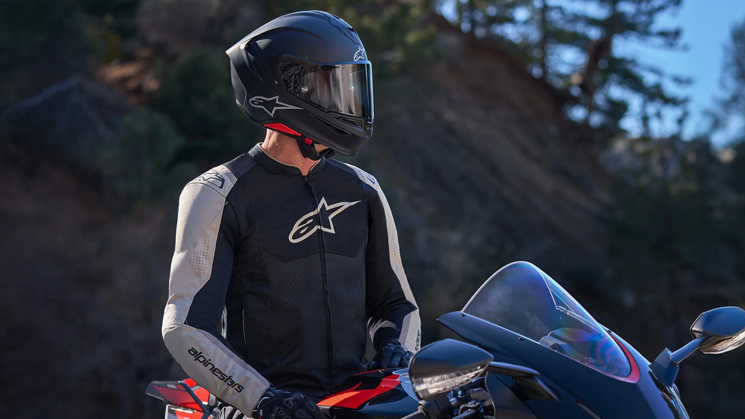 A new motorcycle rider wearing a full protective gear setup, demonstrating the "All The Gear, All The Time" principle for beginner safety.