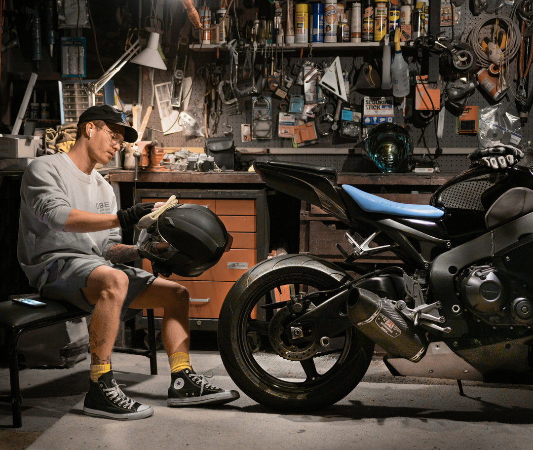 rider performing helmet maintenance in his garage