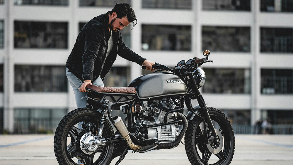 A motorcycle rider with his cafe racer.