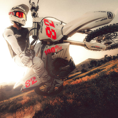 100% ARmatic Goggles - Clear Lens - Lifestyle angled shot of rider on white dirt bike