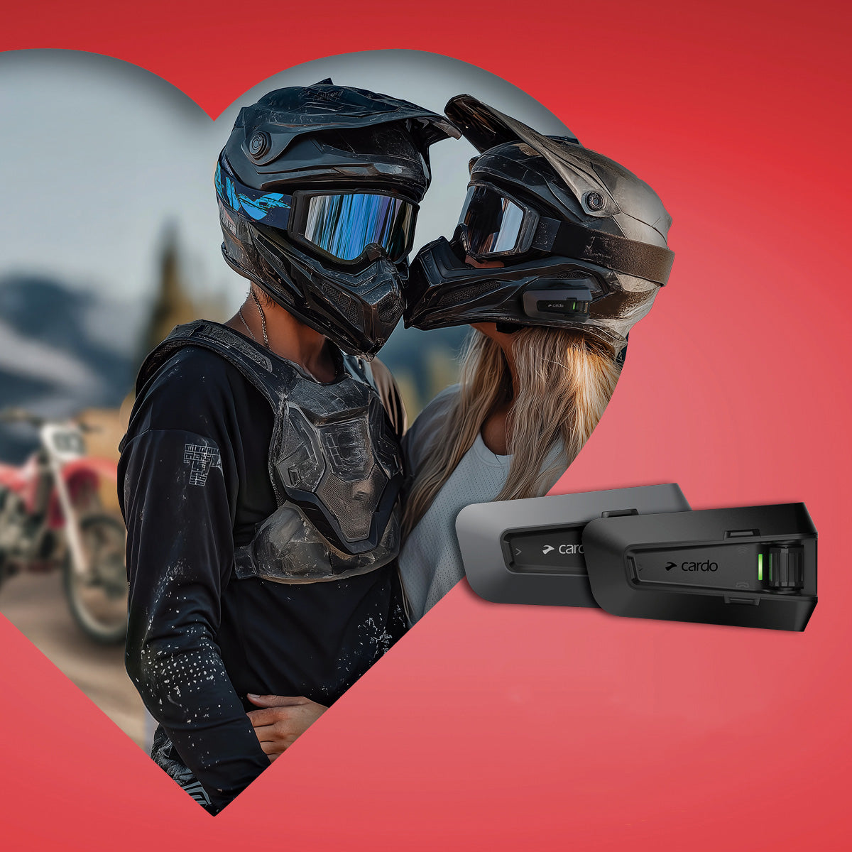 Valentine's Day Sale Card - picture of couple in enduro gear and helmets posing for a mock kiss while framed by off-center pink heart cut-out with Cardo Packtalk Systems overlaid on righthand side