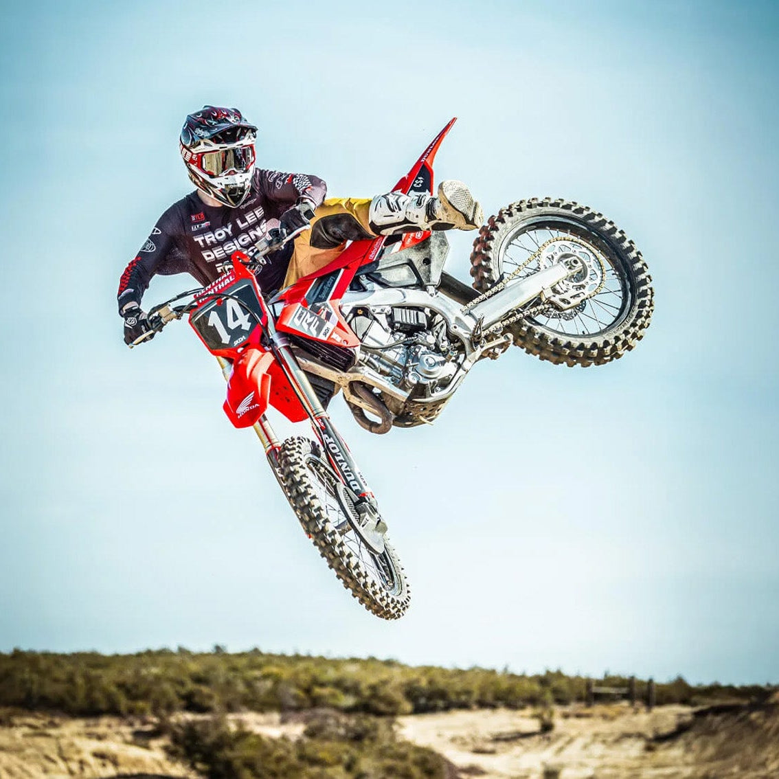 Lifestyle image of dirt rider doing jump trick while wearing Troy Lee Designs GP Pro Helmet