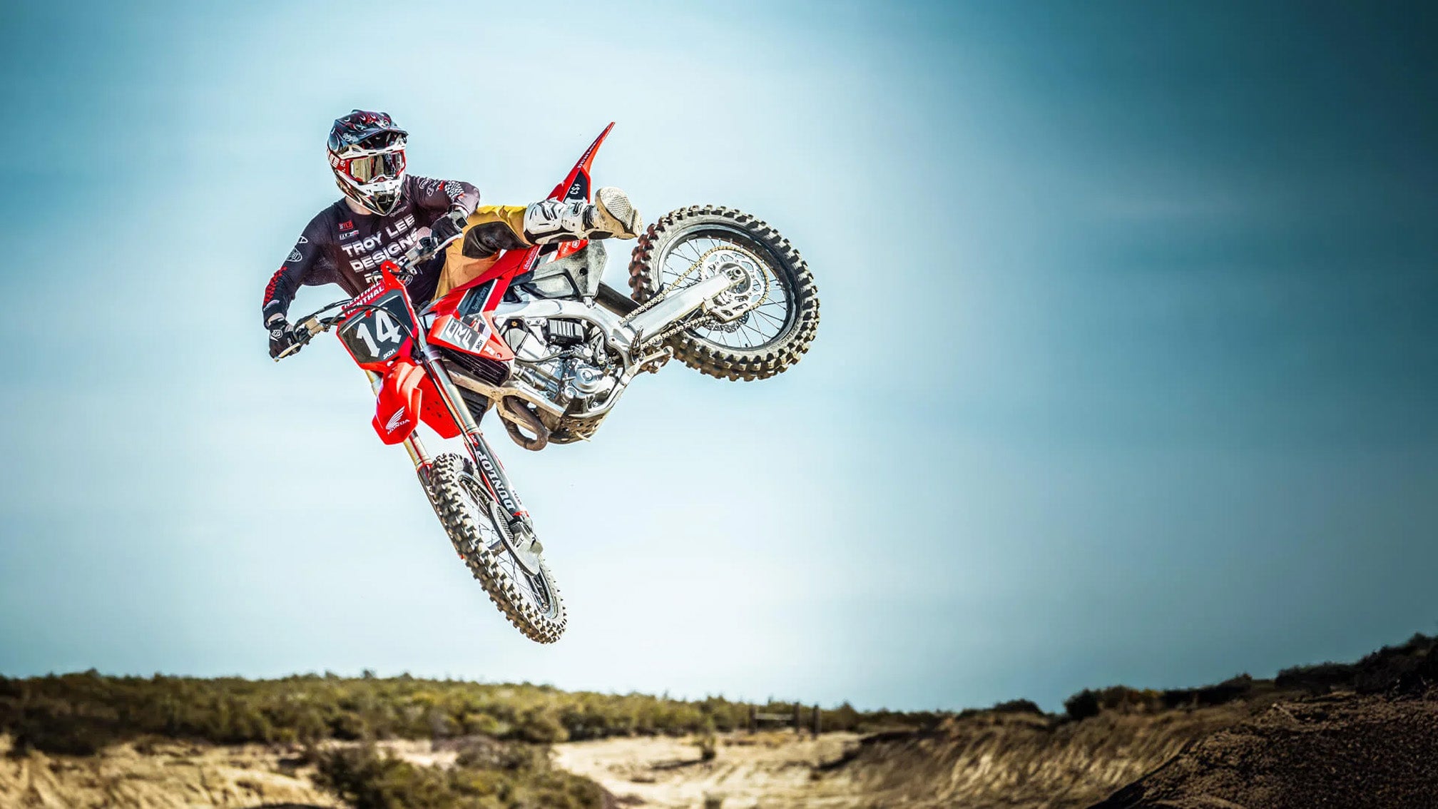 Lifestyle image of dirt rider doing jump trick while wearing Troy Lee Designs GP Pro Helmet