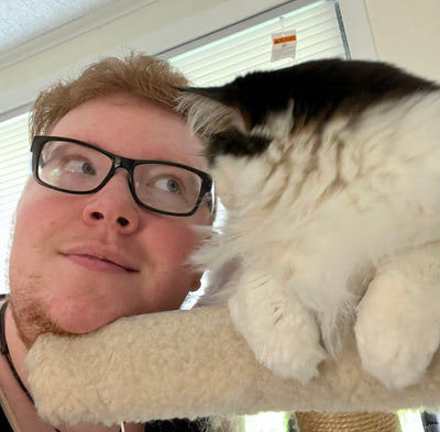 Our Expert, Gray, posing with his cat