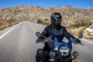 Rider in street gear cruising through the mountains