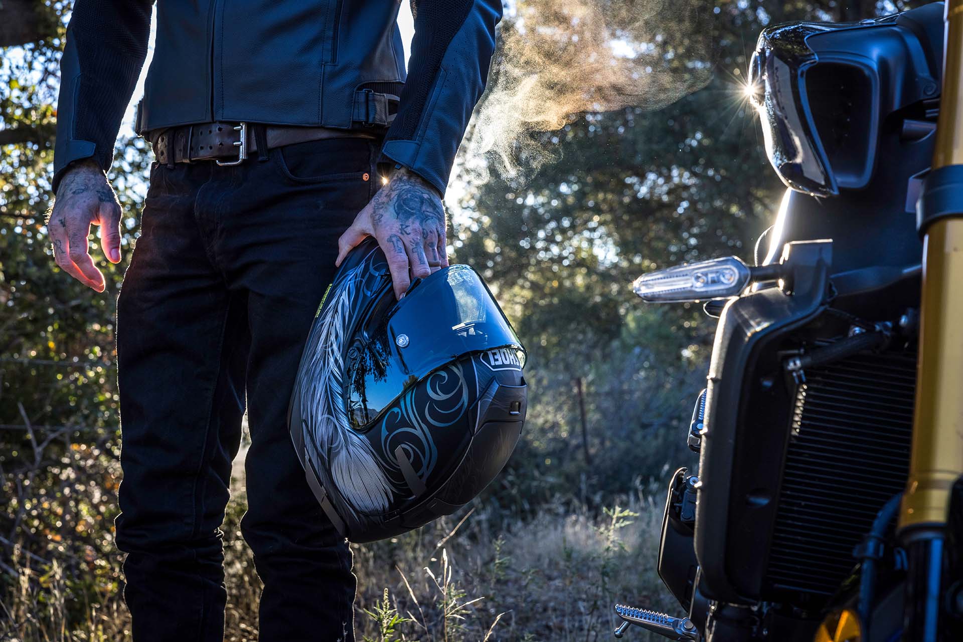 Rider holding Shoei Helmet