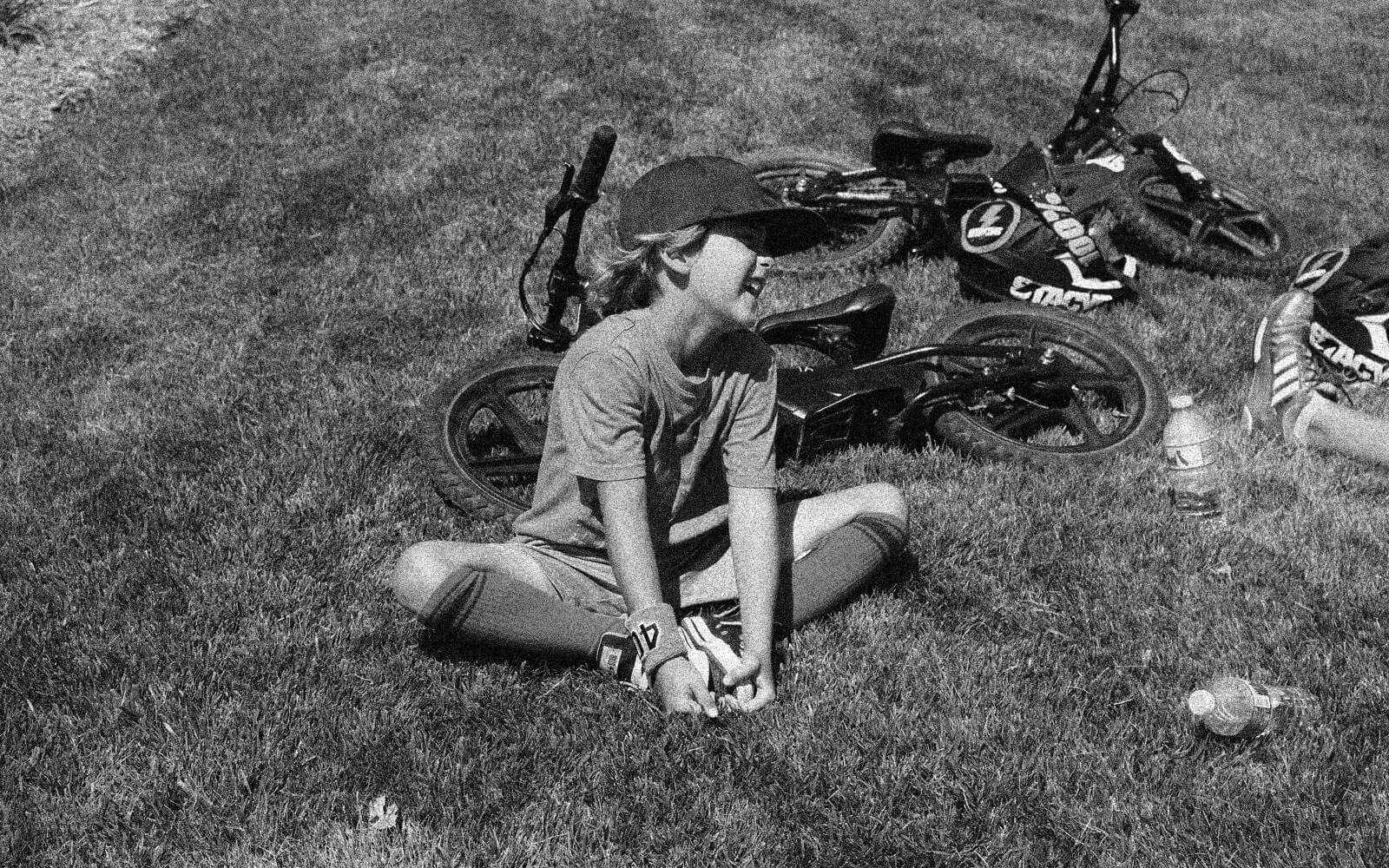 Black-and-white image of kid smiling after riding Stacyc eBike