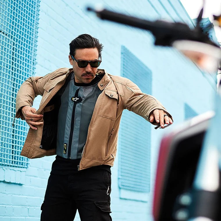 Rider pulling jacket over Alpinestars Tech-Air 5 Air Bag Vest