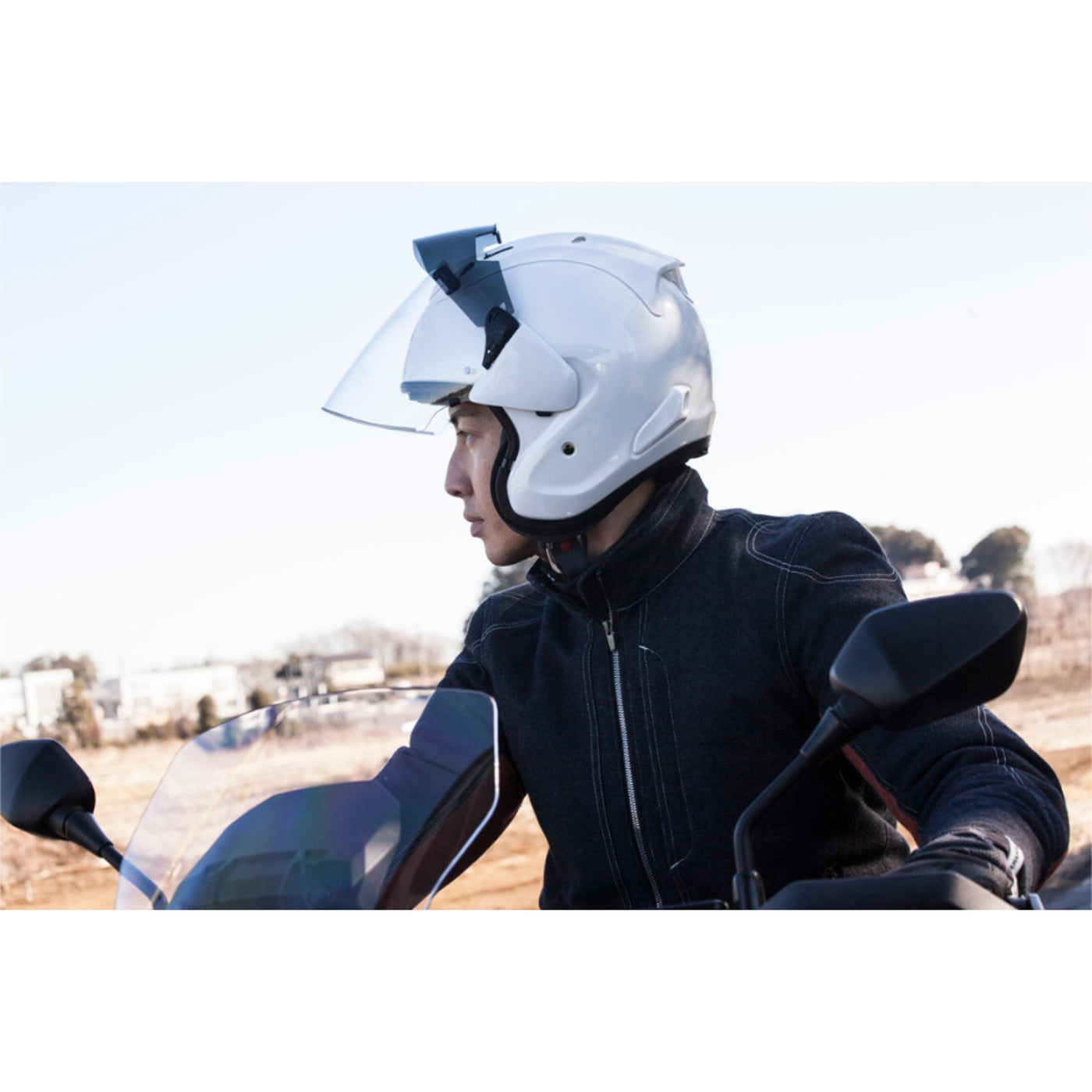 Arai Ram-X Solid Helmet Diamond White - Lifestyle Shot of Rider wearing helmet with faceshield raised