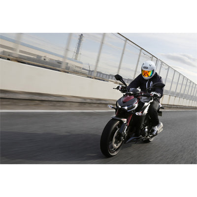 Arai Signet-X Solid Helmet - Lifestyle Wide Shot of rider in white helmet on black motorcycle