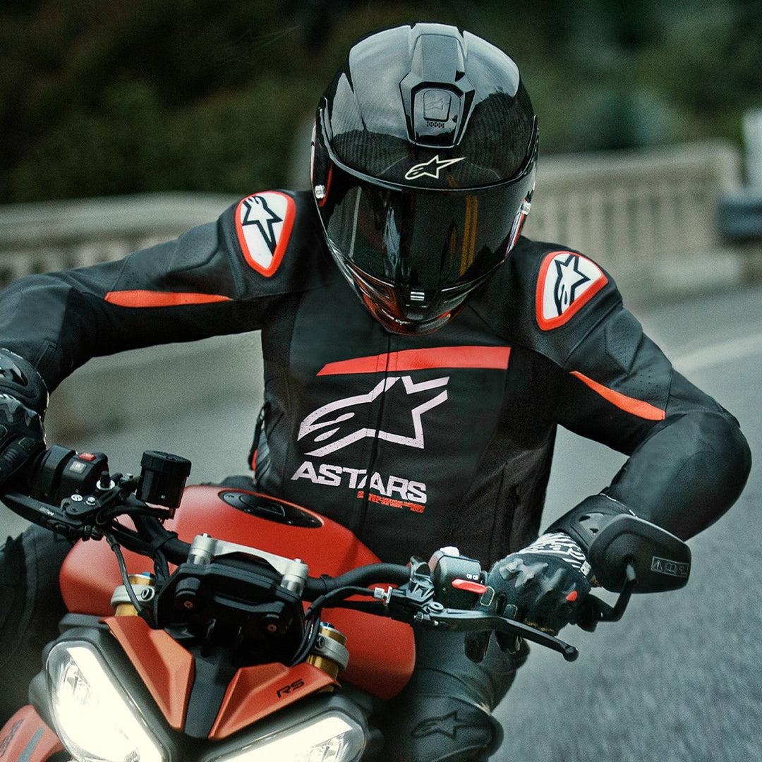 Alpinestars GP Plus R V4 Airflow Leather Jacket Black/Red Fluo/White - Lifestyle head-on shot of rider wearing jacket on red motorcycle