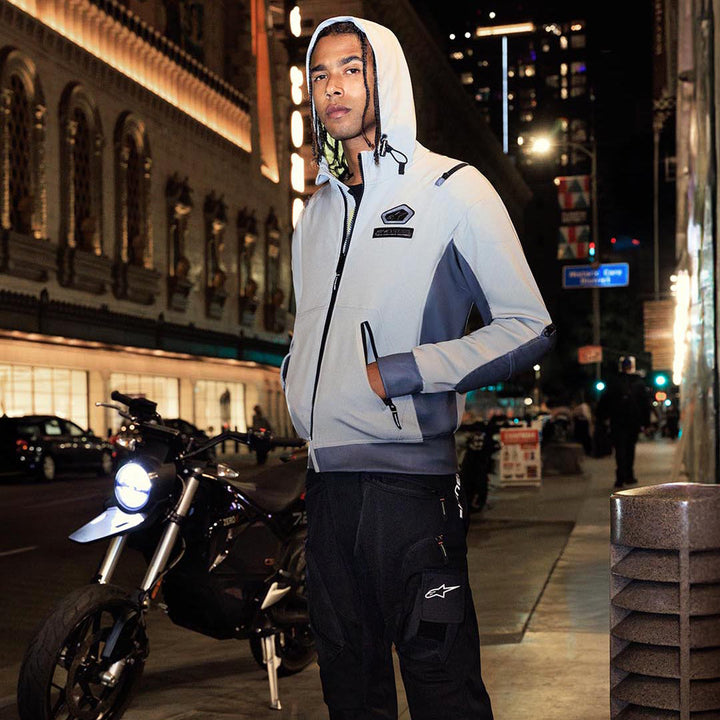 Alpinestars Moblast Waterproof Jacket Iron Gray/Dark Sage - Lifestyle Image of Model Posing in Jacket on City Street at Night