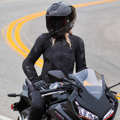 Alpinestars Stella T-GP Plus R V4 Airflow Jacket Black/Black - Lifestyle shot of rider wearing jacket on black motorcycle