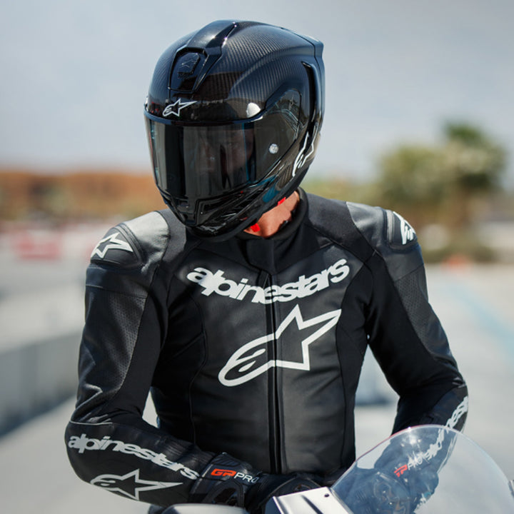 Alpinestars Supertech R10 Solid Helmet Carbon Black - Lifestyle shot of rider wearing helmet