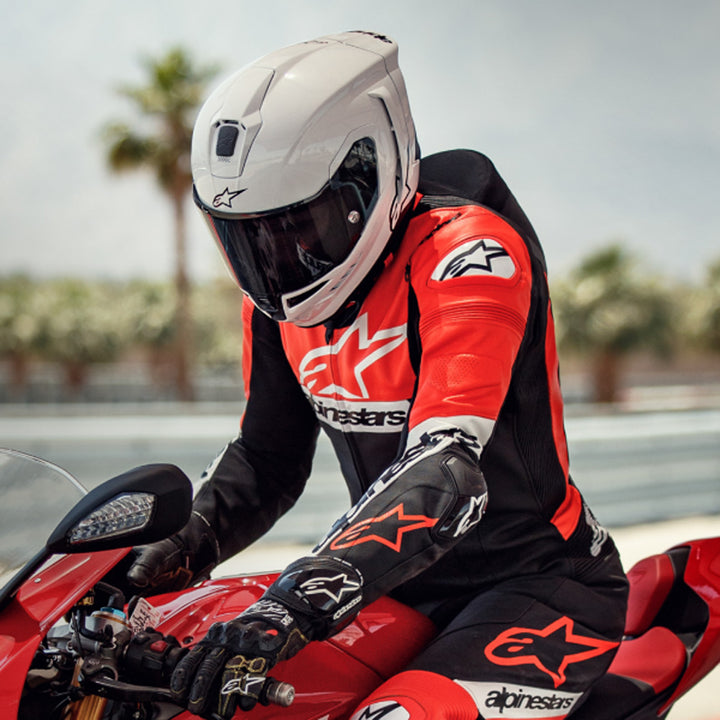 Alpinestars Supertech R10 Solid Helmet Gloss White - Lifestyle shot of rider wearing helmet on red sport motorcycle