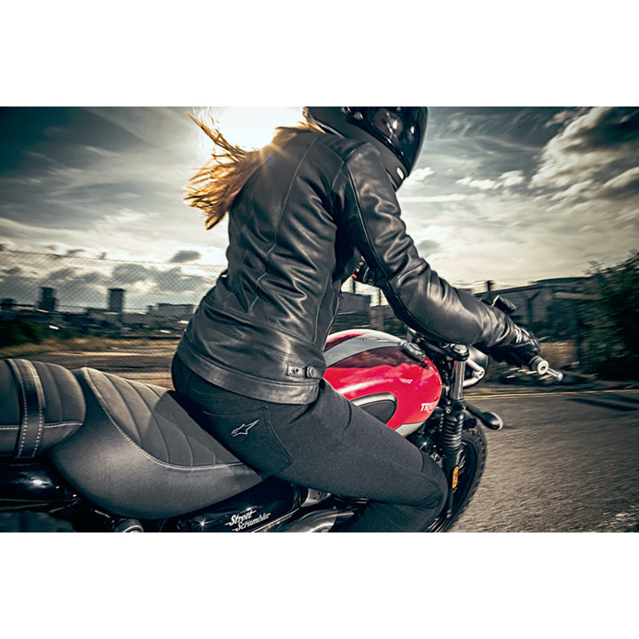 Alpinestars Stella Banshee Pants - Lifestyle shot of rider wearing leggings on red motorcycle