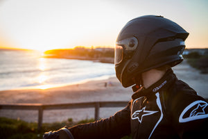 Rider wearing Bell Racestar Helmet looking towards sunset