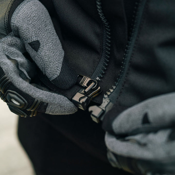 Cortech Men's Hyper-Tec 2.0 Jacket Black/White - Lifestyle Close-Up of rider zipping up jacket