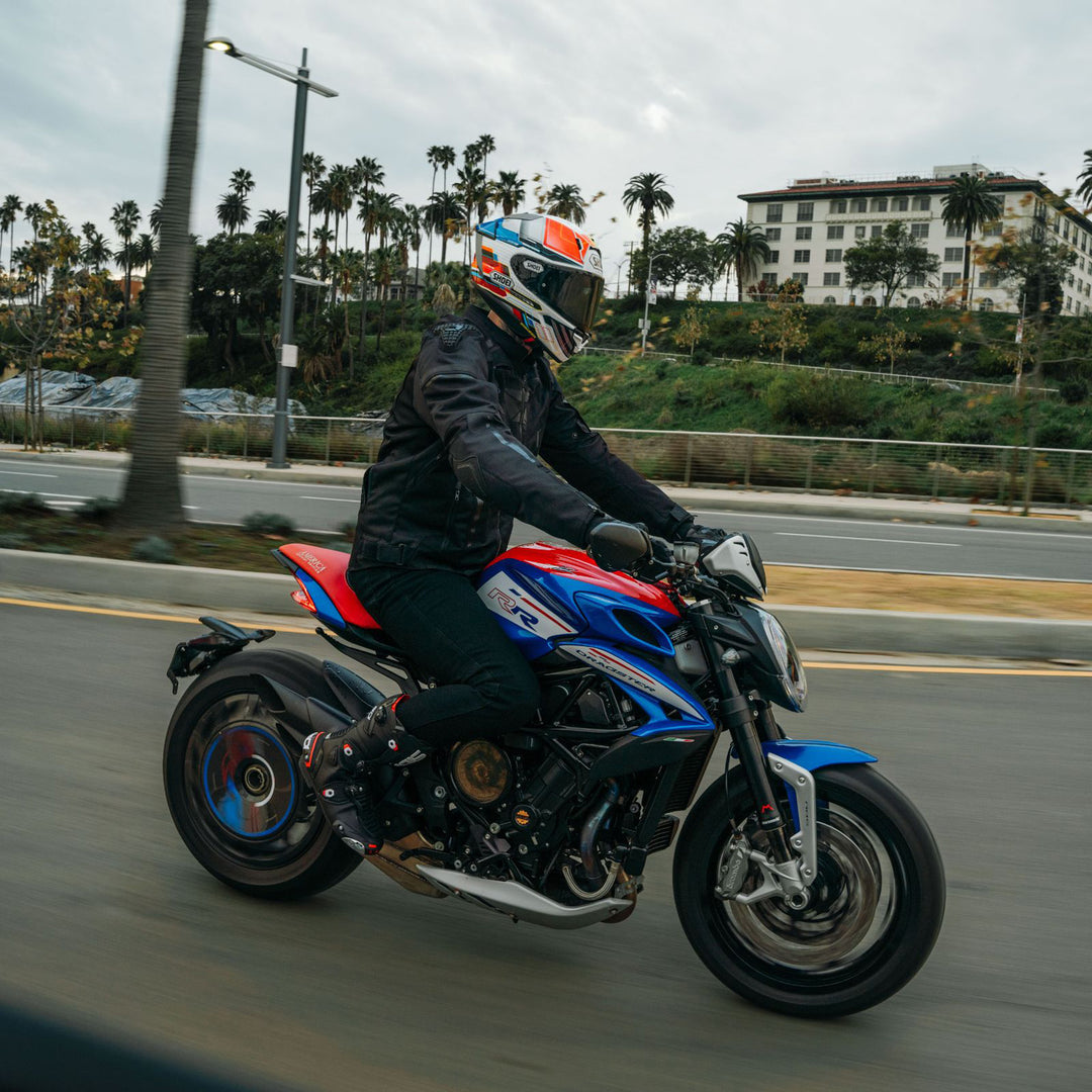 Cortech Men's Hyper-Tec 2.0 Jacket Black/White - Lifestyle of rider wearing jacket while riding on blue motorcycle