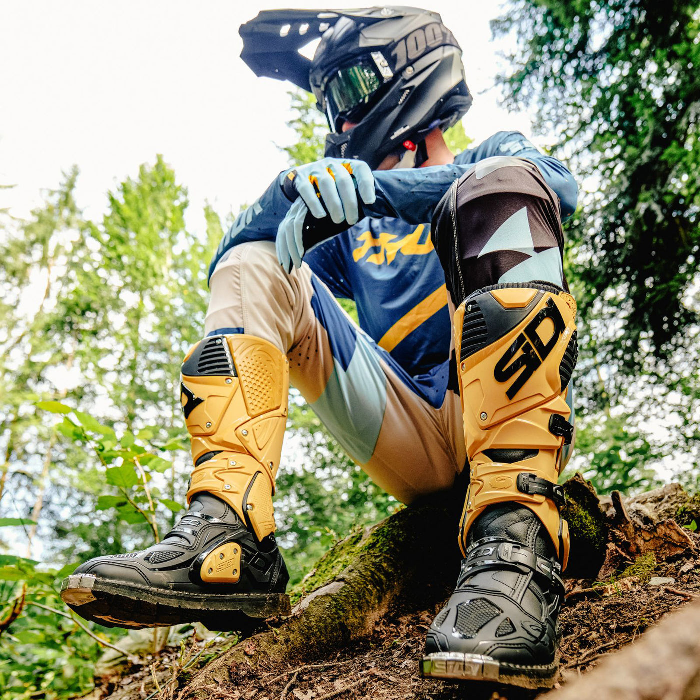 Sidi Crossfire 3 TA Boot Gold/Black - Lifestyle Shot of Rider Sitting on Root While Wearing Boots