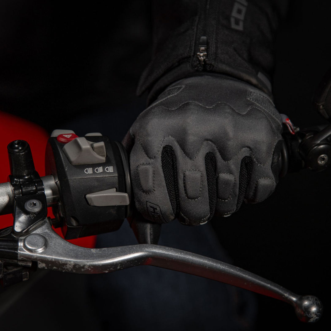 Cortech Lite Gloves Black/Black - Lifestyle Close-Up of Gloved Hand Gripping Motorcycle Grip