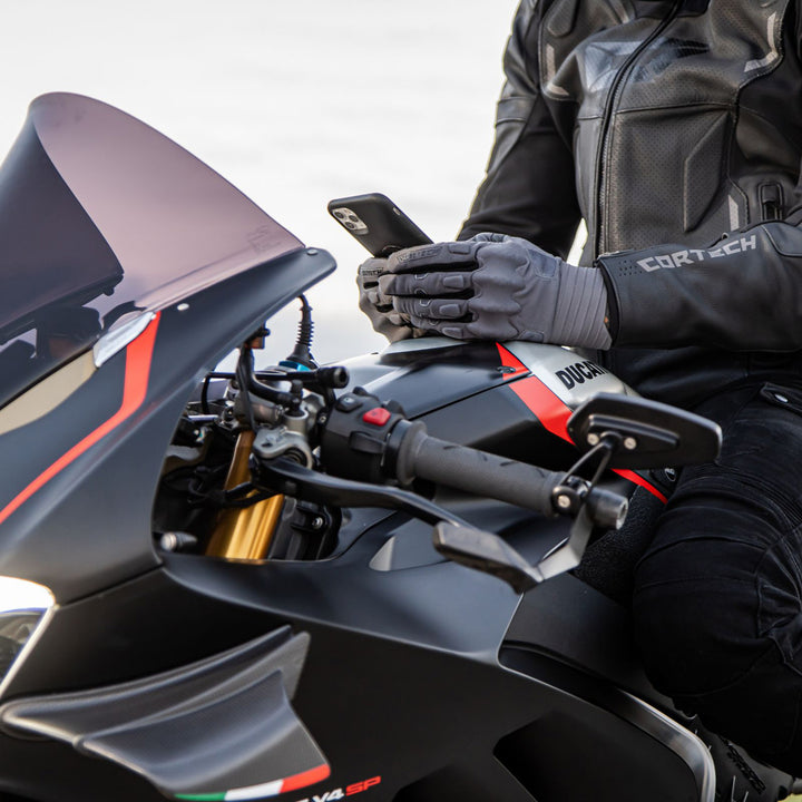 Cortech Lite Gloves Grey/Black - Lifestyle Shot of Rider wearing gloves while checking phone