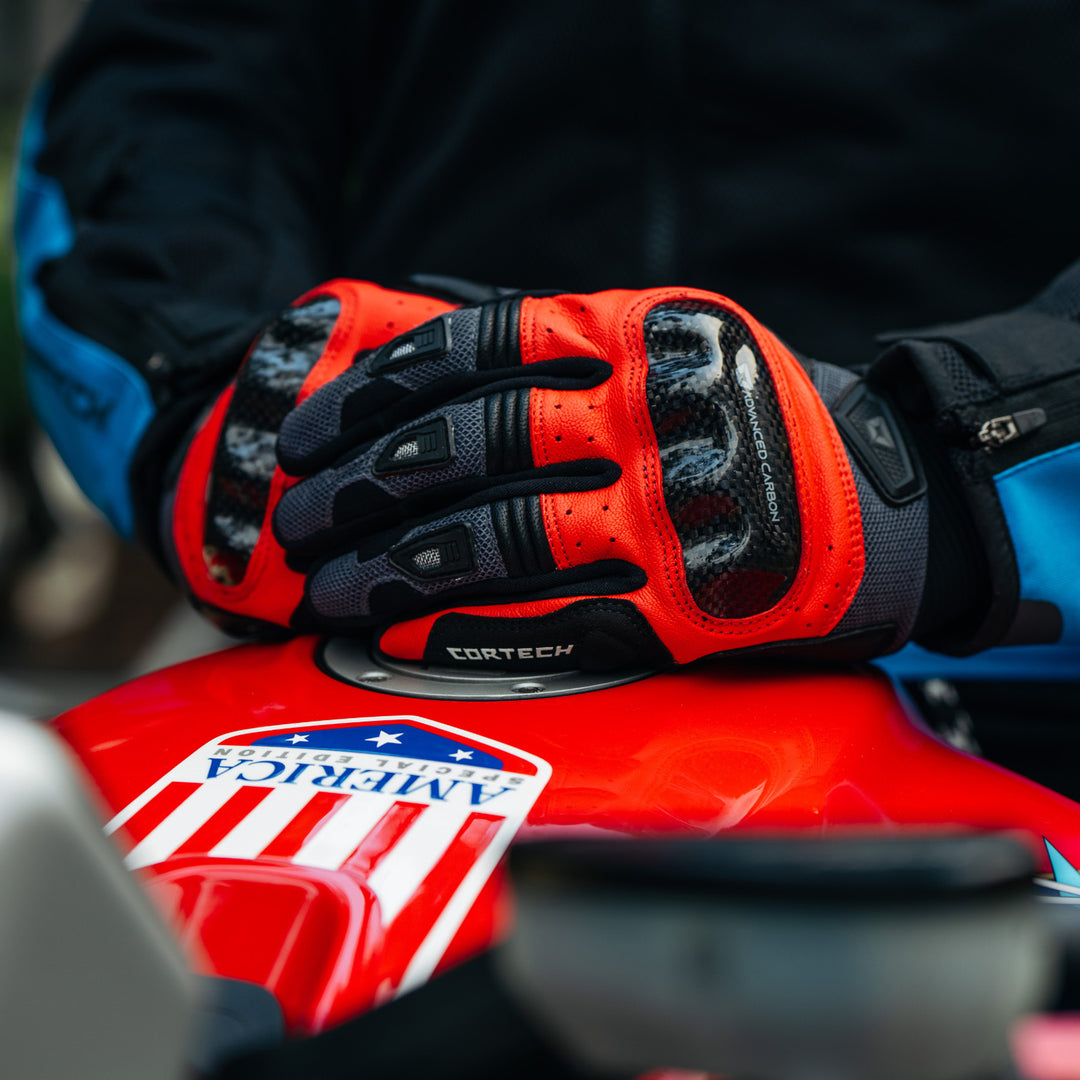 Cortech Apex Air Gloves Red - Lifestyle Close-Up of Gloved Hands Resting on Motorcycle Tank