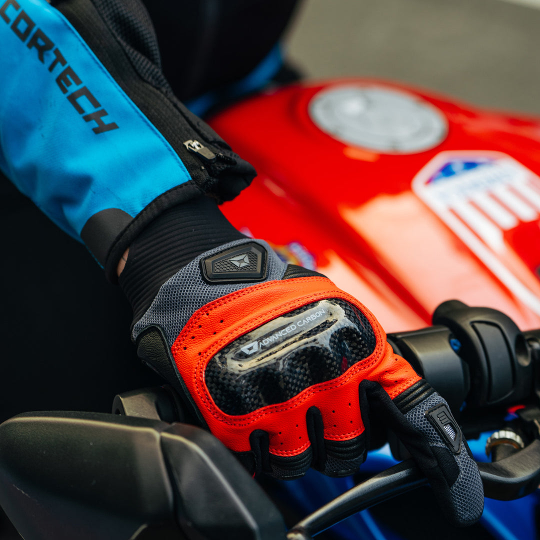 Cortech Apex Air Gloves Red - Lifestyle Close-Up of Gloved Hand Gripping Throttle Grip