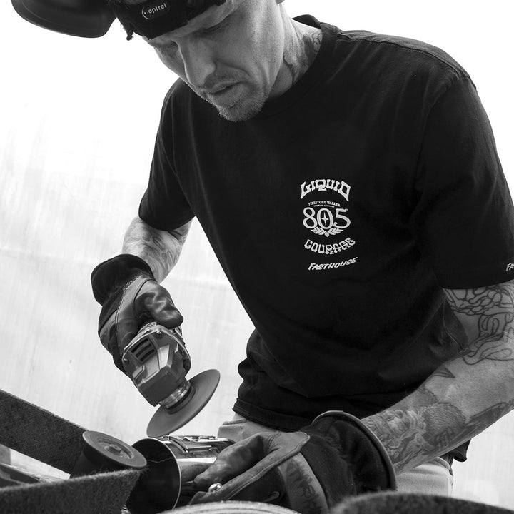 Fasthouse 805 Liquid Courage Tee Black - Lifestyle Shot of Mechanic wearing shit
