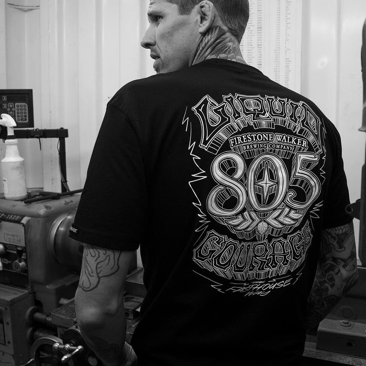 Fasthouse 805 Liquid Courage Tee Black - Lifestyle Shot of Mechanic wearing shit