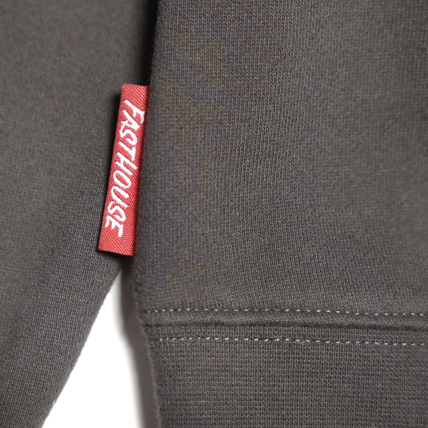 Fasthouse Carrera Crew Neck Pullover Charcoal - Close-Up of Logo Tag Sewn into Seam