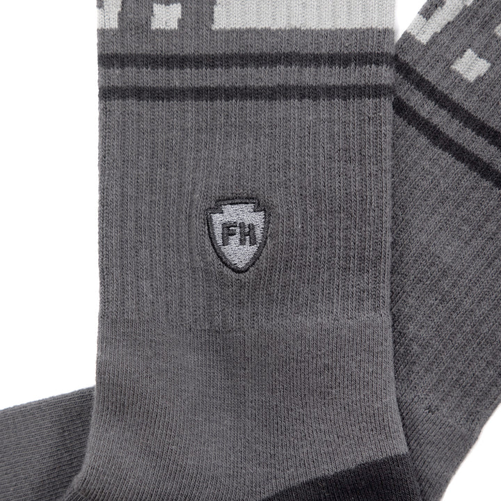 Fasthouse Dozer Crew Socks Dark Gray - Close-Up Side View of Stitched Logo