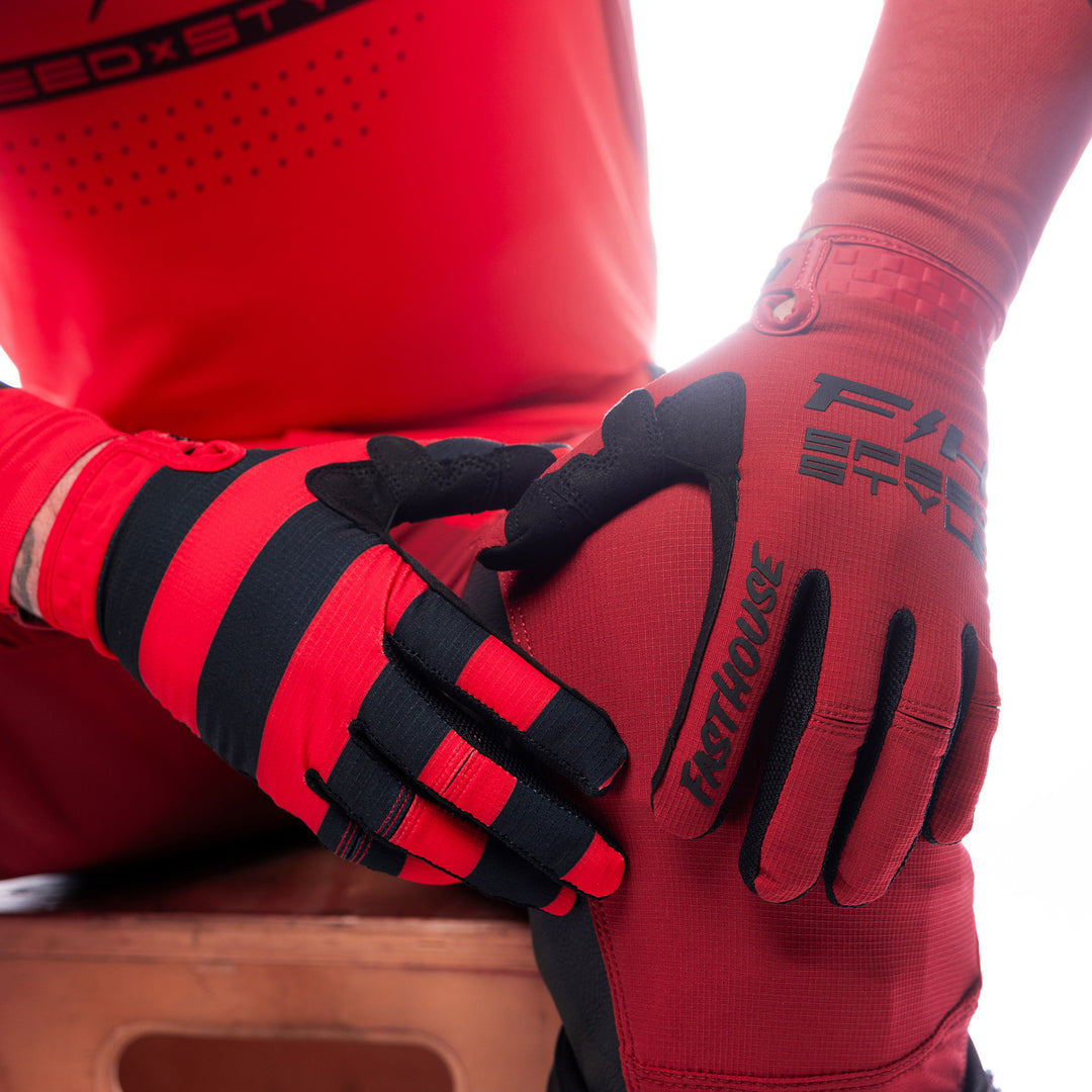 Fasthouse Elrod Ether Gloves Red/Jester Red - Close-Up of Model's Gloved Hands Resting on Knee