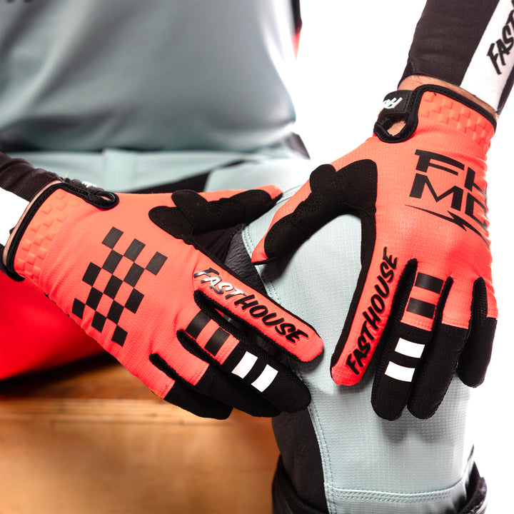 Fasthouse Elrod Formula Gloves Hyper Coral - Close-Up of Model Wearing Gloves, Hands Resting on Left Knee