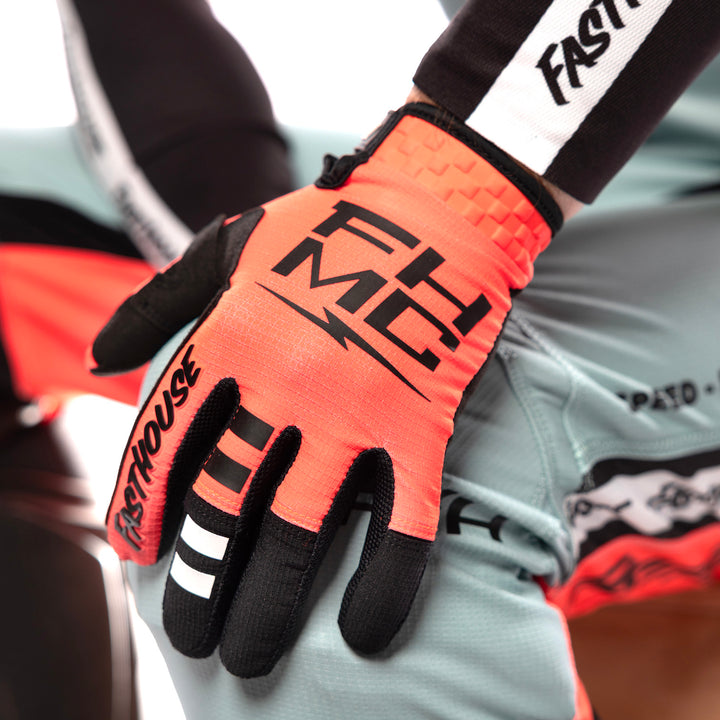Fasthouse Elrod Formula Gloves Hyper Coral - Close-Up of Model Wearing Gloves, Resting Left Hand on Left Knee