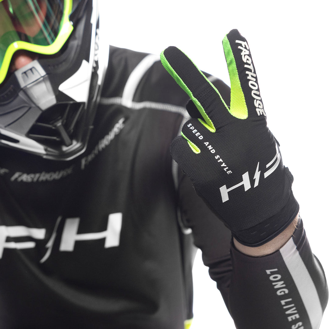 Fasthouse Elrod Nitro Gloves Black Neon - Close-Up of Model Wearing Gloves, Holding Up Left Hand in Peace Sign