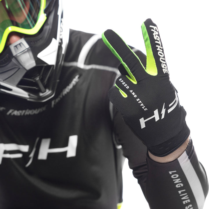 Fasthouse Elrod Nitro Gloves Black Neon - Close-Up of Model Wearing Gloves, Holding Up Left Hand in Peace Sign