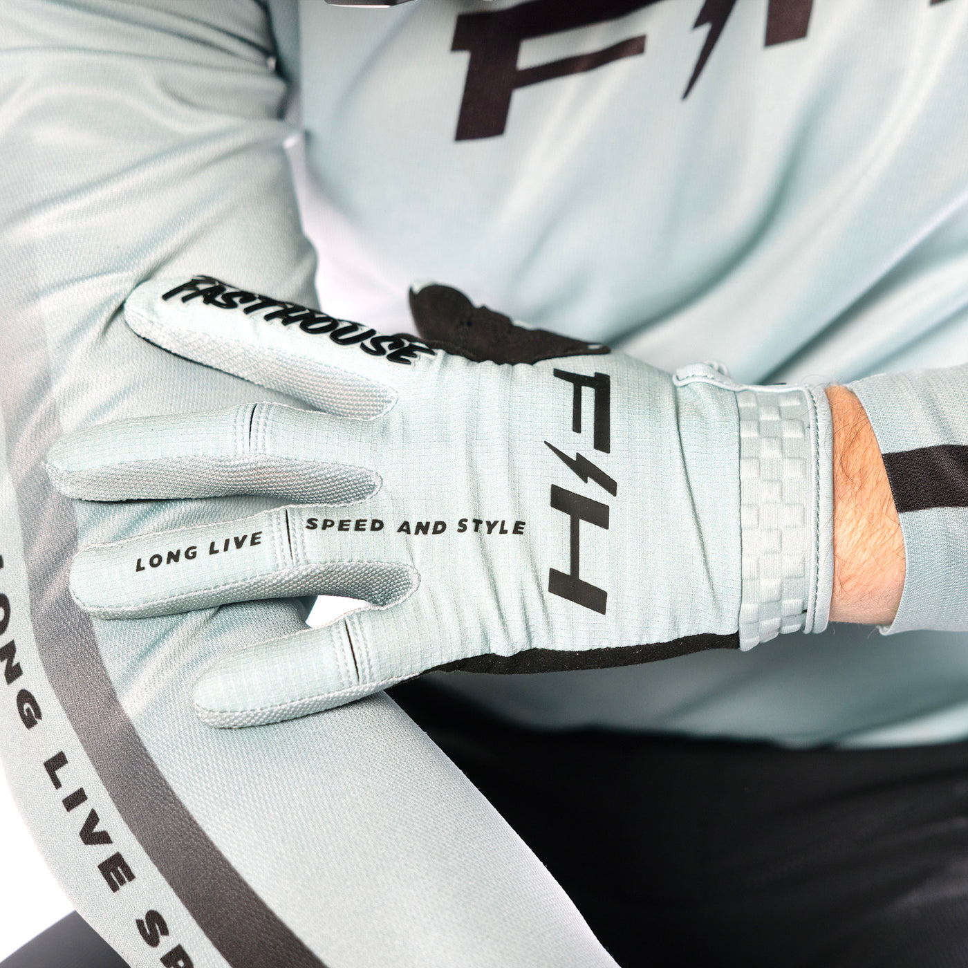 Fasthouse Elrod Nitro Gloves Oceanic Mint - Close-Up of Model Wearing Gloves, Holding Left Hand Over Right Arm