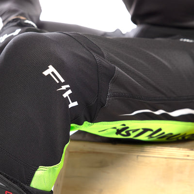Fasthouse Elrod Nitro Pants Black Neon - Close-Up of Left Knee Graphic