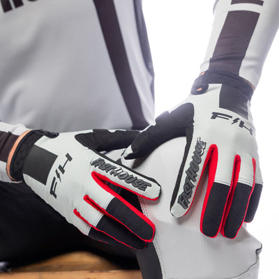 Fasthouse Elrod Storm Gloves Fog/Black - Close-Up of Model's Gloved Hands Resting on Knee