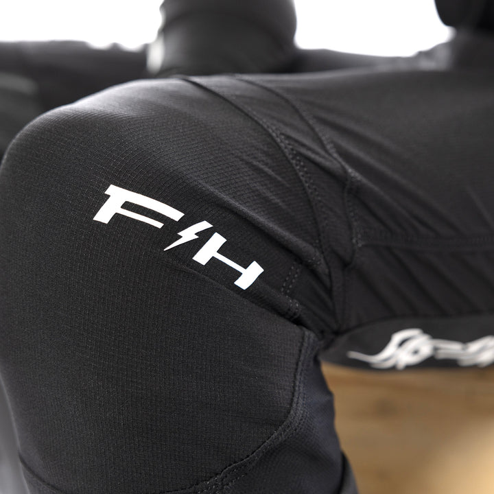 Fasthouse Elrod Torque Pants Black - Close-Up of Left Knee Graphics