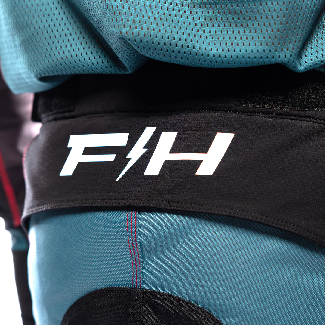 Fasthouse Grindhouse Club Pants Light Gray/Black/Teal - Close-Up of Rear Waist Graphic