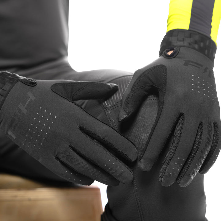 Fasthouse Helix Circuit Gloves Black - Close-Up of Model Wearing Gloves, Hands Resting on Left Knee