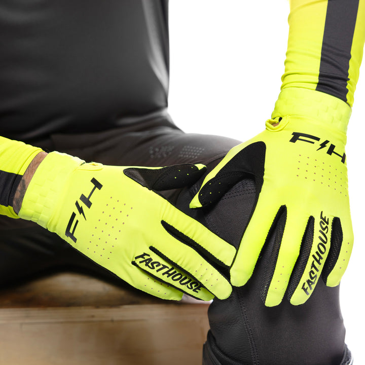 Fasthouse Helix Circuit Gloves High-Viz - Close-Up of Model Wearing Gloves, Resting Hands on Left Knee