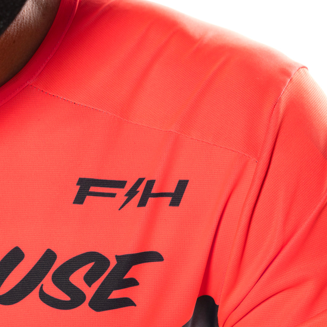 Fasthouse Helix Circuit Jersey Hyper Coral/Black - Close-Up of Front Left Shoulder Graphics