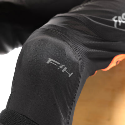 Fasthouse Helix Circuit Pants Black/Hyper Coral - Close-Up of Left Knee Grapihcs